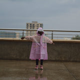 Girl standing on a rooftop with a cityscape in the background