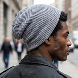 Man wearing a gray beanie on a city street