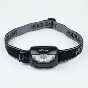 A black and gray headlight with an adjustable elastic strap, featuring the brand name 'Hauvi' printed on the front of the light housing and 'HEADLIGHT' repeated on the strap.
